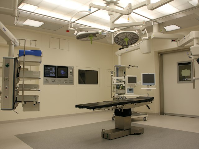 Operating theatre with a surgical table, overhead lights and medical equipment