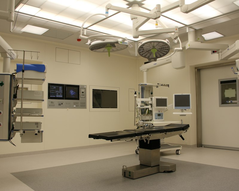 Operating theatre with a surgical table, overhead lights and medical equipment